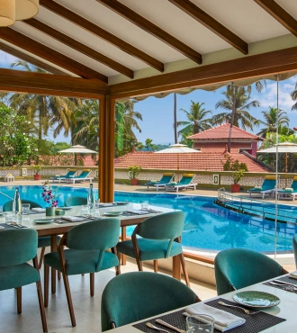 Alfresco dining setup at Paani Pourri, the poolside restaurant at Devaaya Resort Goa