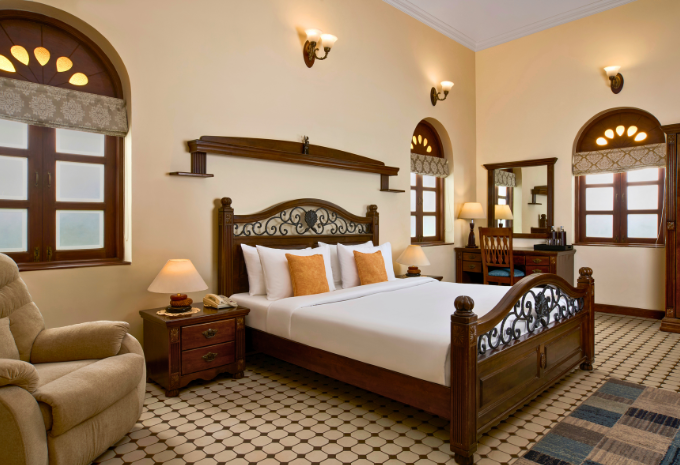 King-sized bed in the Maharaja Suite with Indo-Portuguese decor at Mercure Goa Devaaya Resort