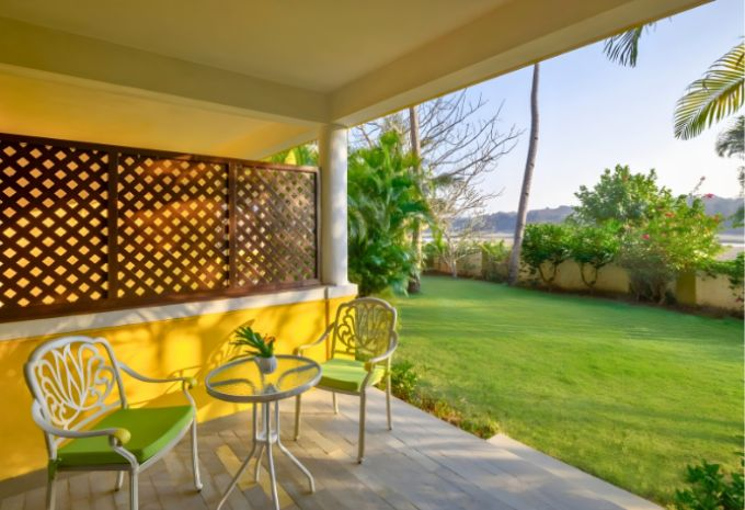 Private veranda with garden views and seating at Mercure Goa Devaaya Resort Divar Island